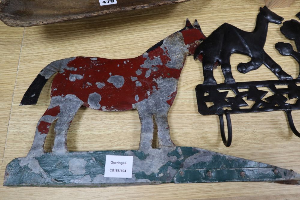 A 19th century sycamore grain shovel, 98cm., a beech wall shelf and two painted sheet metal ornaments